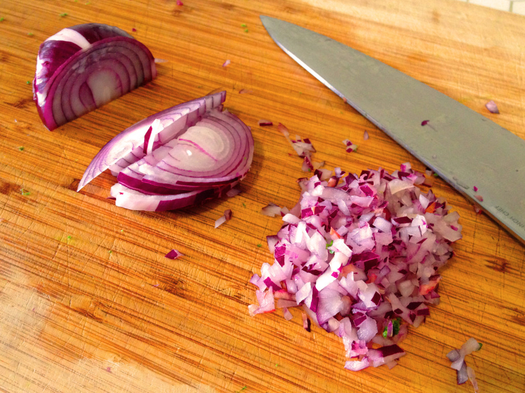 The red onion should be chopped as finely as possible, so as not to overwhelm the taste of the Kale Slaw with Sesame Honey Dijon Dressing. Photo © Ben Young Landis.
